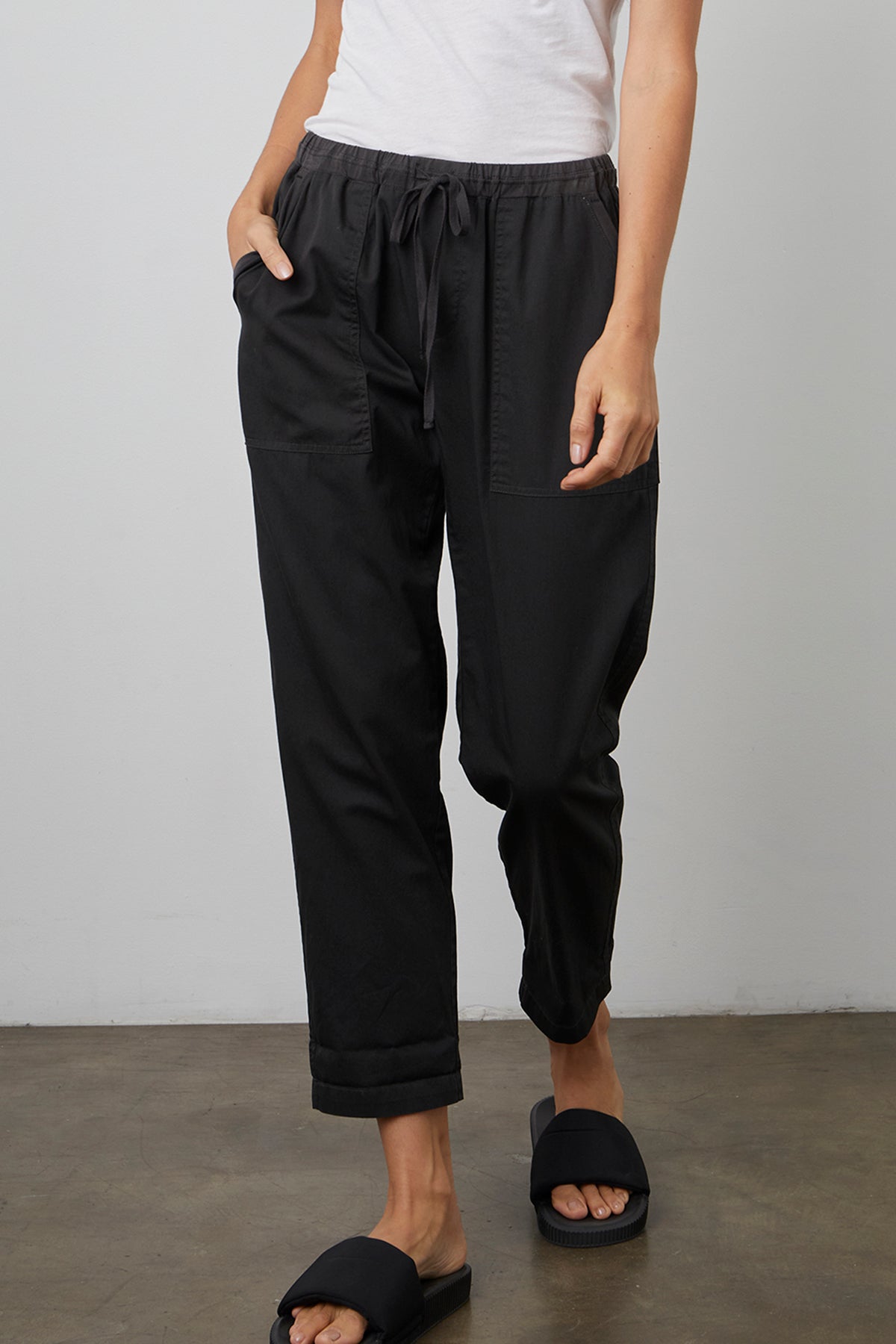 MIsty cotton twill pant in onyx black front with model's hand in pocket.-25275770536132