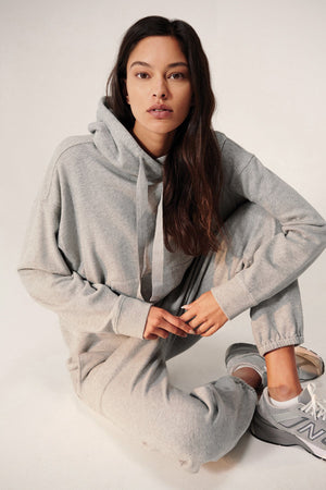 a model wearing ZUMA SWEATPANT by Velvet by Jenny Graham and sneakers.